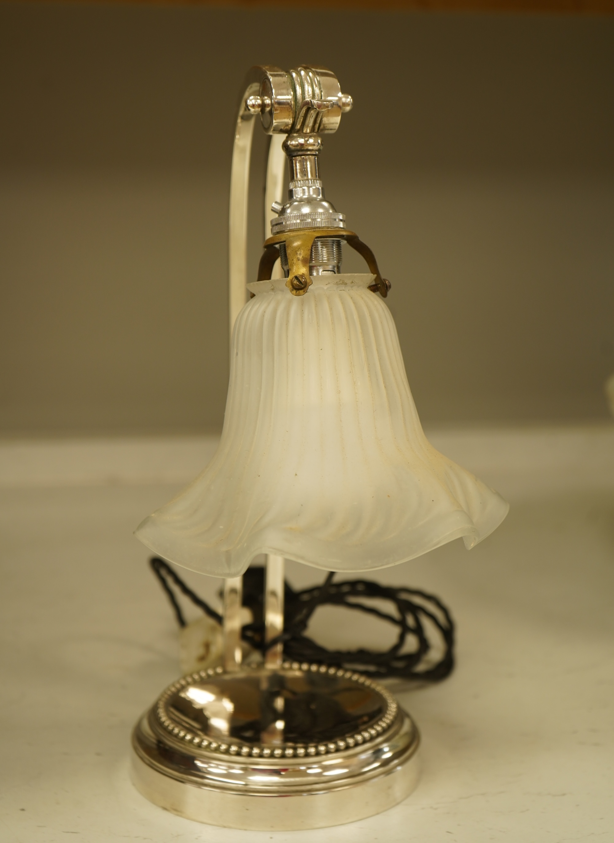A plated adjustable desk light with opaque glass fluted shade, 35cm high